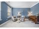 Cozy living room with blue walls, two chairs, and a piano near window at 136 Stagecoach Ln, Summerville, SC 29483