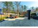 Backyard patio featuring a hot tub, pergola swing, umbrella, and outdoor seating at 136 Stagecoach Ln, Summerville, SC 29483