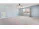 Bright bedroom featuring a ceiling fan, neutral carpet, large window, and white shelves at 136 Stagecoach Ln, Summerville, SC 29483