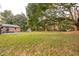 Expansive backyard featuring lush greenery, a shed, and mature trees, offering a tranquil setting at 1491 Seacroft Rd, James Island, SC 29412