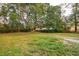 Expansive backyard featuring a mature tree and hammock, perfect for relaxation and outdoor activities at 1491 Seacroft Rd, James Island, SC 29412