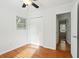 Bright bedroom with hardwood floors, closet, and a window providing natural light at 1491 Seacroft Rd, James Island, SC 29412