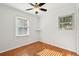 Bright bedroom with hardwood floors, natural light from the windows, and fresh white paint at 1491 Seacroft Rd, James Island, SC 29412