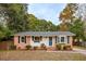 Charming brick home with a blue front door, decorative window box, and black shutters at 1491 Seacroft Rd, James Island, SC 29412