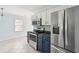 Bright kitchen with stainless steel appliances, blue cabinets, and tile backsplash at 1491 Seacroft Rd, James Island, SC 29412
