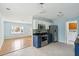 Open-concept kitchen with stainless steel appliances and hardwood floors, leading to a living area at 1491 Seacroft Rd, James Island, SC 29412