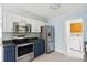 Well-lit kitchen featuring stainless steel appliances, updated cabinets, and tiled flooring at 1491 Seacroft Rd, James Island, SC 29412