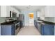 Spacious kitchen featuring blue lower cabinets, stainless appliances, and tiled backsplash at 1491 Seacroft Rd, James Island, SC 29412
