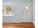 Charming living room featuring wood flooring and a front door next to a bay window at 1491 Seacroft Rd, James Island, SC 29412