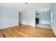 Bright open living room with hardwood floors, light blue walls, and an adjoining kitchen at 1491 Seacroft Rd, James Island, SC 29412