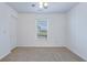 Sunlit bedroom with a ceiling fan, plush carpet, and a view of the outdoors at 152 Coosawatchie St, Summerville, SC 29485