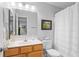 Well-lit bathroom with a single sink vanity, framed mirror, and shower-tub combo at 2012 Long Bend Drive, Seabrook Island, SC 29455