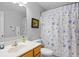 Neutral bathroom with a single sink vanity and seashell-themed shower curtain at 2012 Long Bend Drive, Seabrook Island, SC 29455