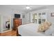 Bedroom featuring a bed, dresser, and windows with wooden shutters at 2012 Long Bend Drive, Seabrook Island, SC 29455