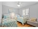 Bright bedroom with two twin beds, ceiling fan, and shuttered window at 2012 Long Bend Drive, Seabrook Island, SC 29455