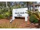 Marsh Walk Villas community sign amid lush landscaping and coastal foliage near the beach at 2012 Long Bend Drive, Seabrook Island, SC 29455