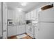 Bright kitchen features white cabinets, stainless appliances, and wood floors at 2012 Long Bend Drive, Seabrook Island, SC 29455
