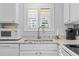 Bright kitchen featuring a window over the sink and granite countertops at 2012 Long Bend Drive, Seabrook Island, SC 29455