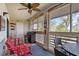 Charming screened porch with a swing, bar seating, a ceiling fan, and peaceful outdoor views at 2012 Long Bend Drive, Seabrook Island, SC 29455
