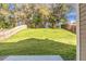Grassy backyard is surrounded by mature shade trees and a wood fence at 212 Medford Dr, Summerville, SC 29485