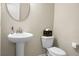 Powder room with pedestal sink, round mirror, and toilet with decorative accents at 212 Medford Dr, Summerville, SC 29485