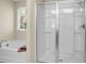 A bathroom featuring a soaking tub, and a glass door walk-in shower at 212 Medford Dr, Summerville, SC 29485