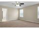 A carpeted bedroom features a ceiling fan, and natural light from the windows at 212 Medford Dr, Summerville, SC 29485