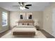 Bedroom with a ceiling fan, a queen bed, two windows and tan carpet at 212 Medford Dr, Summerville, SC 29485