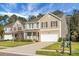Inviting two-story home with tan siding, well-kept lawn, and a convenient two-car garage at 212 Medford Dr, Summerville, SC 29485