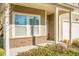 Close-up of charming brick-base front porch with white columns and large double windows at 212 Medford Dr, Summerville, SC 29485