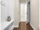 Hallway with dark wood floors, white trim, and a decorative bench with hooks at 212 Medford Dr, Summerville, SC 29485