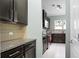 Well-equipped kitchen features tile floors, granite countertops, and dark wood cabinets at 212 Medford Dr, Summerville, SC 29485