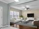 Bright living room with large windows and a modern ceiling fan at 212 Medford Dr, Summerville, SC 29485