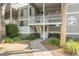 Close-up of a condo's entrance with stairs leading to a private covered balcony at 2135 Landfall Way, Seabrook Island, SC 29455