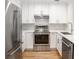 Modern kitchen featuring stainless steel appliances, white cabinets, and a stylish backsplash at 2135 Landfall Way, Seabrook Island, SC 29455