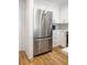 Modern kitchen features a stainless steel KitchenAid refrigerator, white cabinets, and hardwood floors at 2135 Landfall Way, Seabrook Island, SC 29455