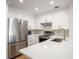 Bright modern kitchen features stainless steel appliances, white cabinets, and stylish backsplash at 2135 Landfall Way, Seabrook Island, SC 29455