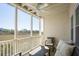 Inviting screened porch with comfortable seating and a ceiling fan, showcasing marsh views at 2135 Landfall Way, Seabrook Island, SC 29455