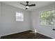 Bright, empty bedroom with two windows and ceiling fan at 2218 Dover St, North Charleston, SC 29405