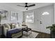 Cozy living room with a sofa and coffee table, featuring a ceiling fan and natural light at 2218 Dover St, North Charleston, SC 29405