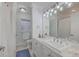 Well-lit bathroom with double vanity, updated fixtures, decorative window, and tile floors at 2410 Trent St, Charleston, SC 29414
