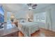 Bright bedroom with hardwood floors, ceiling fan, dresser and two windows with natural light at 2410 Trent St, Charleston, SC 29414