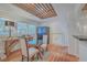 Bright dining room with glass top table, decorative ceiling, lots of light and a very secure safe at 2410 Trent St, Charleston, SC 29414