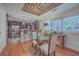 Bright dining room open to kitchen with glass top table, decorative ceiling, and lots of light at 2410 Trent St, Charleston, SC 29414