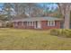 Inviting single-story brick home featuring black shutters and a lush green lawn at 2410 Trent St, Charleston, SC 29414
