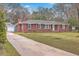Charming single-story brick home with a long driveway and well-manicured lawn at 2410 Trent St, Charleston, SC 29414