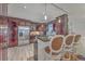 Spacious kitchen with cherry cabinets, stainless steel appliances, granite countertops, and bar stool seating at 2410 Trent St, Charleston, SC 29414