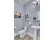 Stylish bathroom features pedestal sink, toilet, modern lighting, and blue walls at 2425 Giles Ln, Mount Pleasant, SC 29466