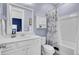 Charming bathroom features white vanity, nautical shower curtain, tub, and tiled floors at 2425 Giles Ln, Mount Pleasant, SC 29466