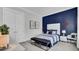 Stylishly decorated bedroom with navy accent wall, comfortable seating and bedside table at 2425 Giles Ln, Mount Pleasant, SC 29466